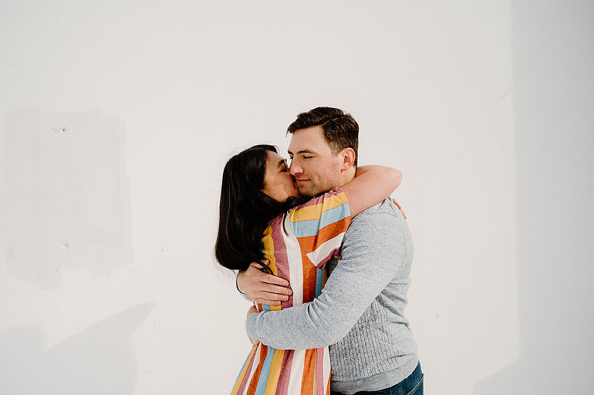 cute modern couple hug during engagement shoot with Denver wedding photographer