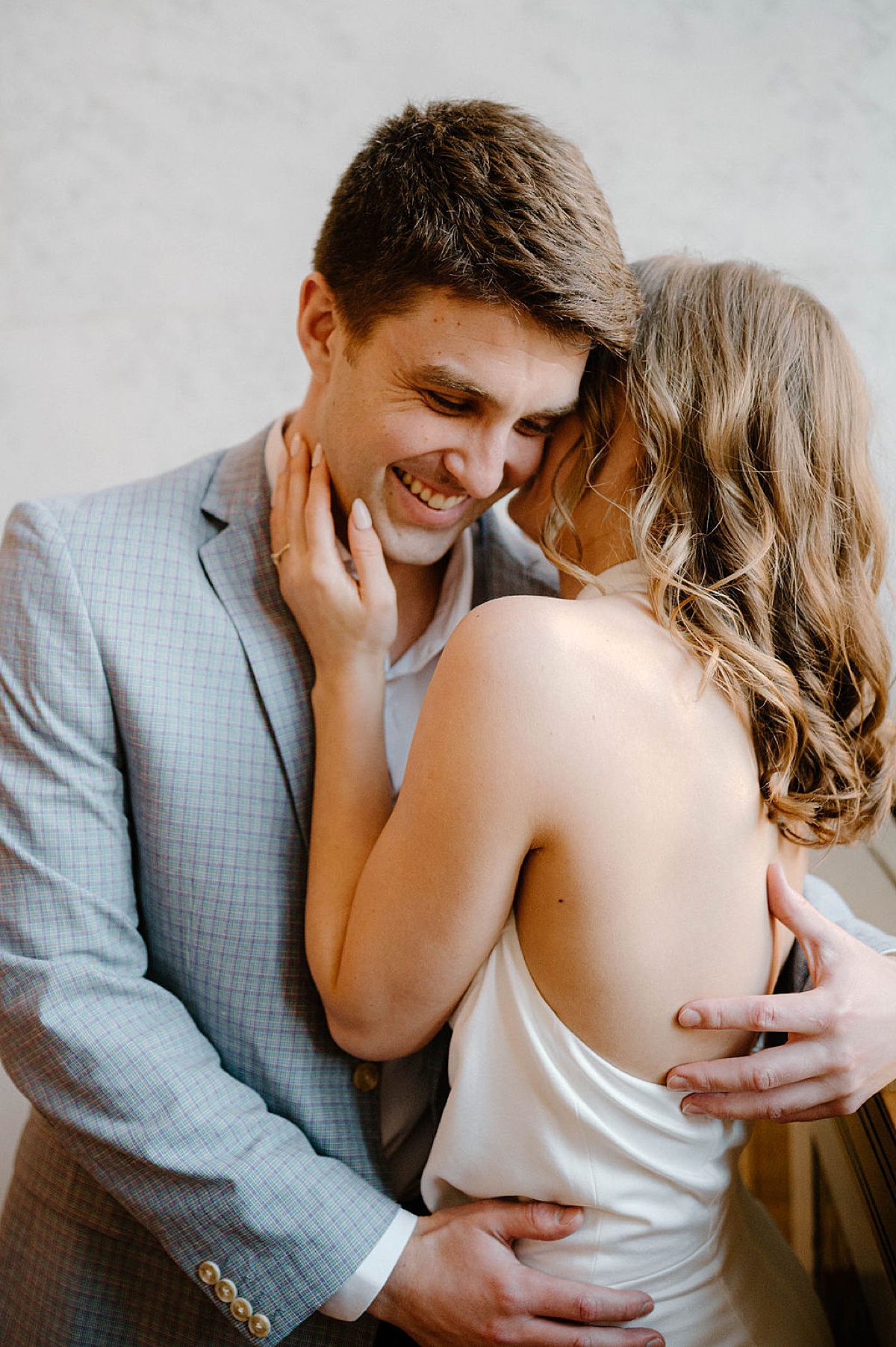 beautiful couple embrace during chic post office engagement session 