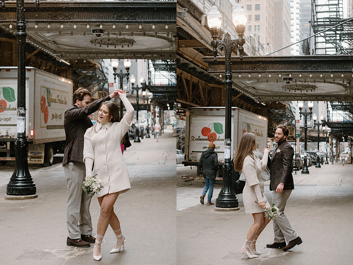 cute couple in mod 60s style coats dance in Chicago streets after elopement shot by Indigo Lace Collective