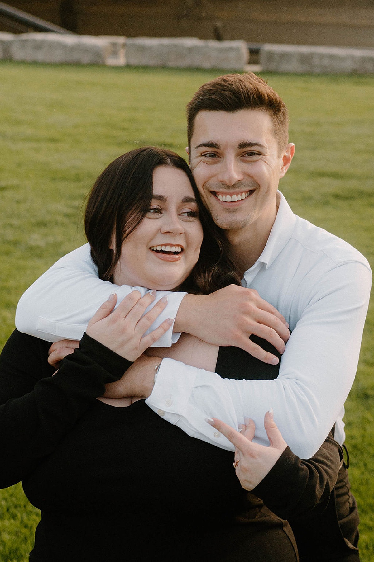 Cute young couple smile during outdoor Indianapolis sunset engagement shoot