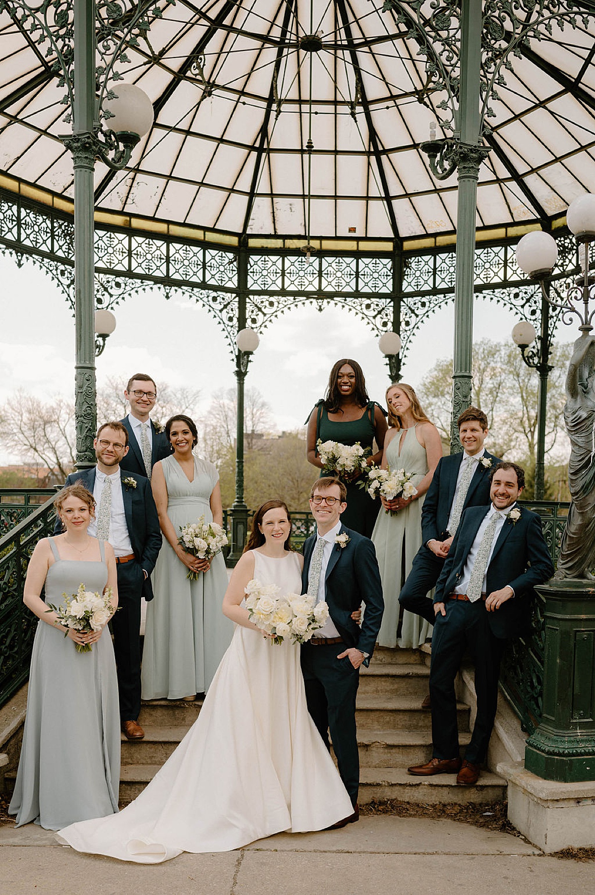 classic bride and groom pose with wedding party before spring wedding at Artifact Events
