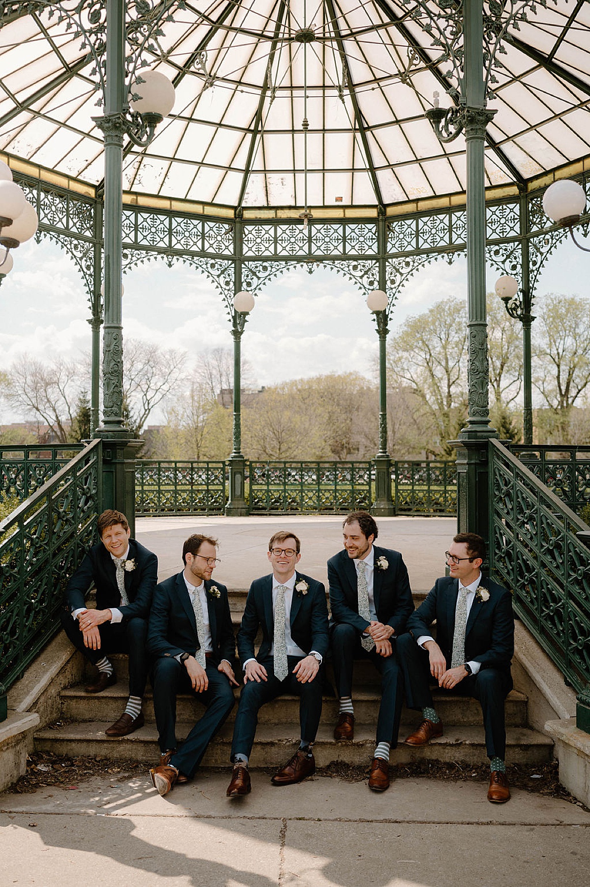 groom and groomsmen wear classic suits and striped socks before wedding shot by Indigo Lace Collective