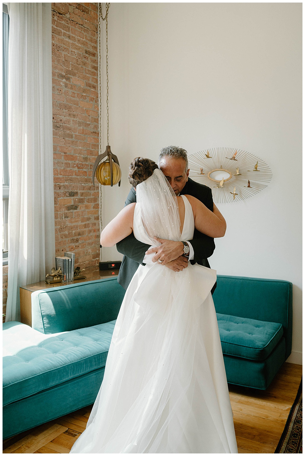 father hugs bride after first look for Bridgeport Art Center wedding