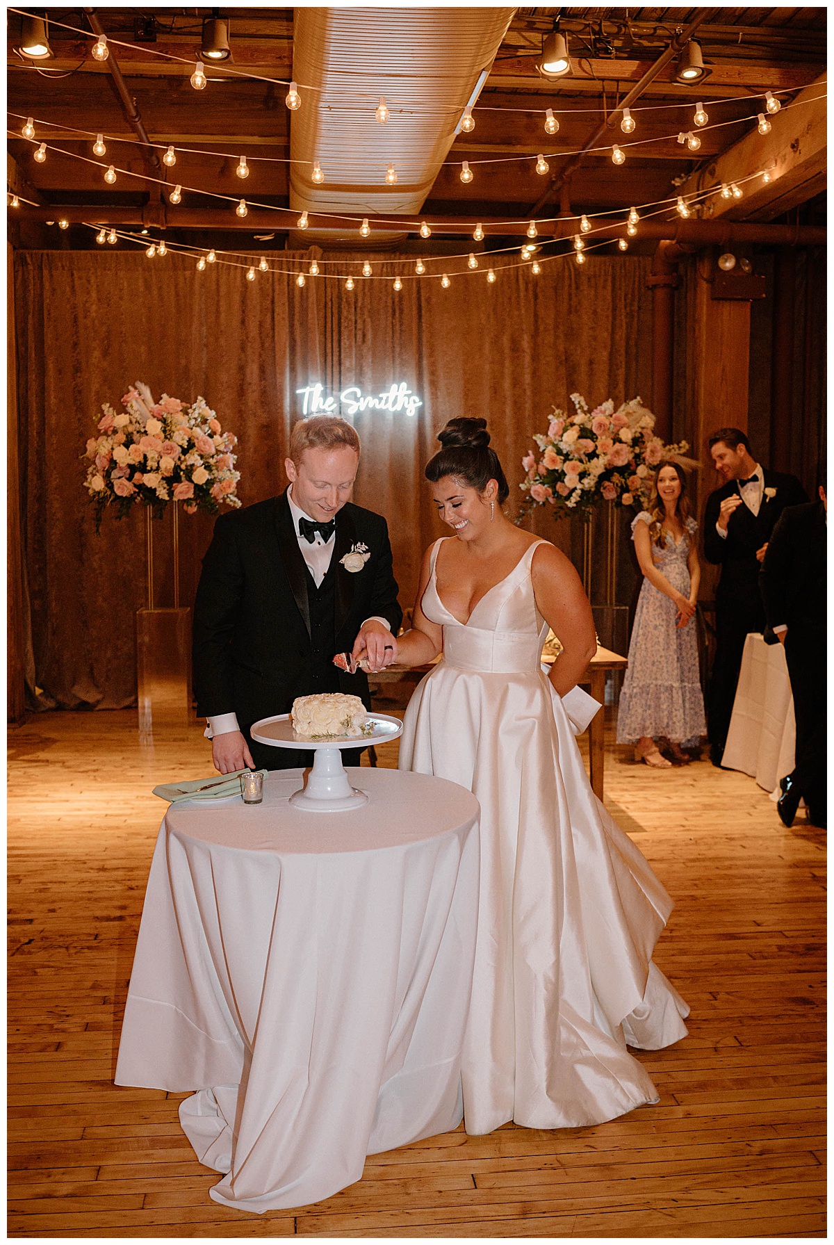 bride and groom cut cake together by Chicago photographer