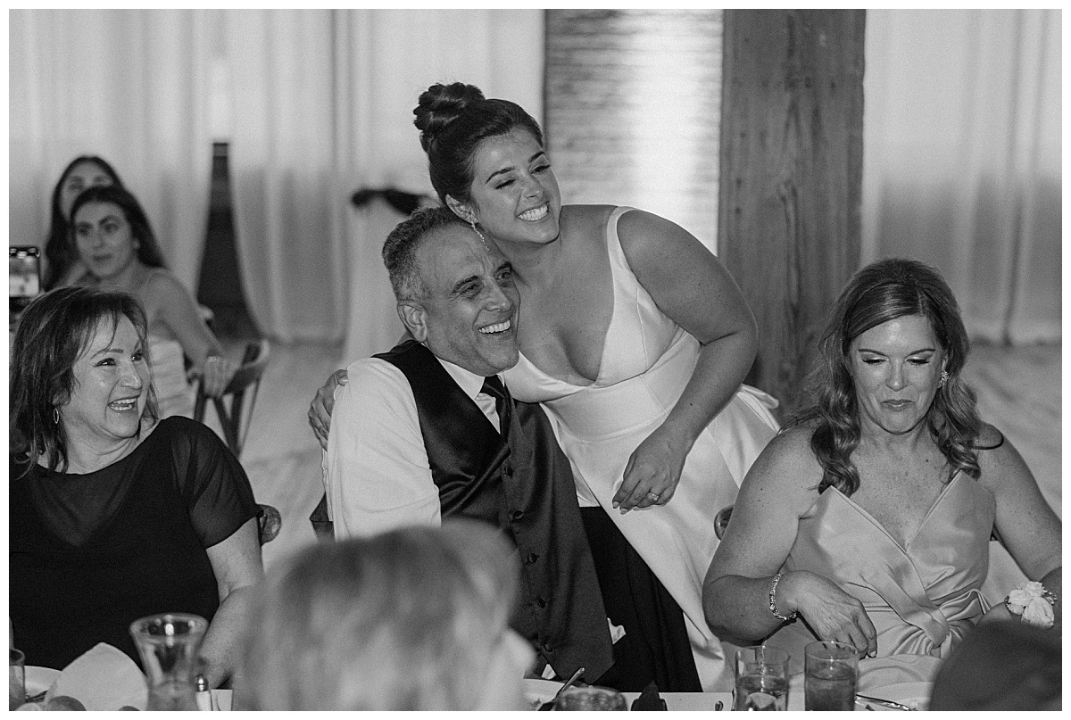 bride hugs father during reception by Indigo Lace Collective