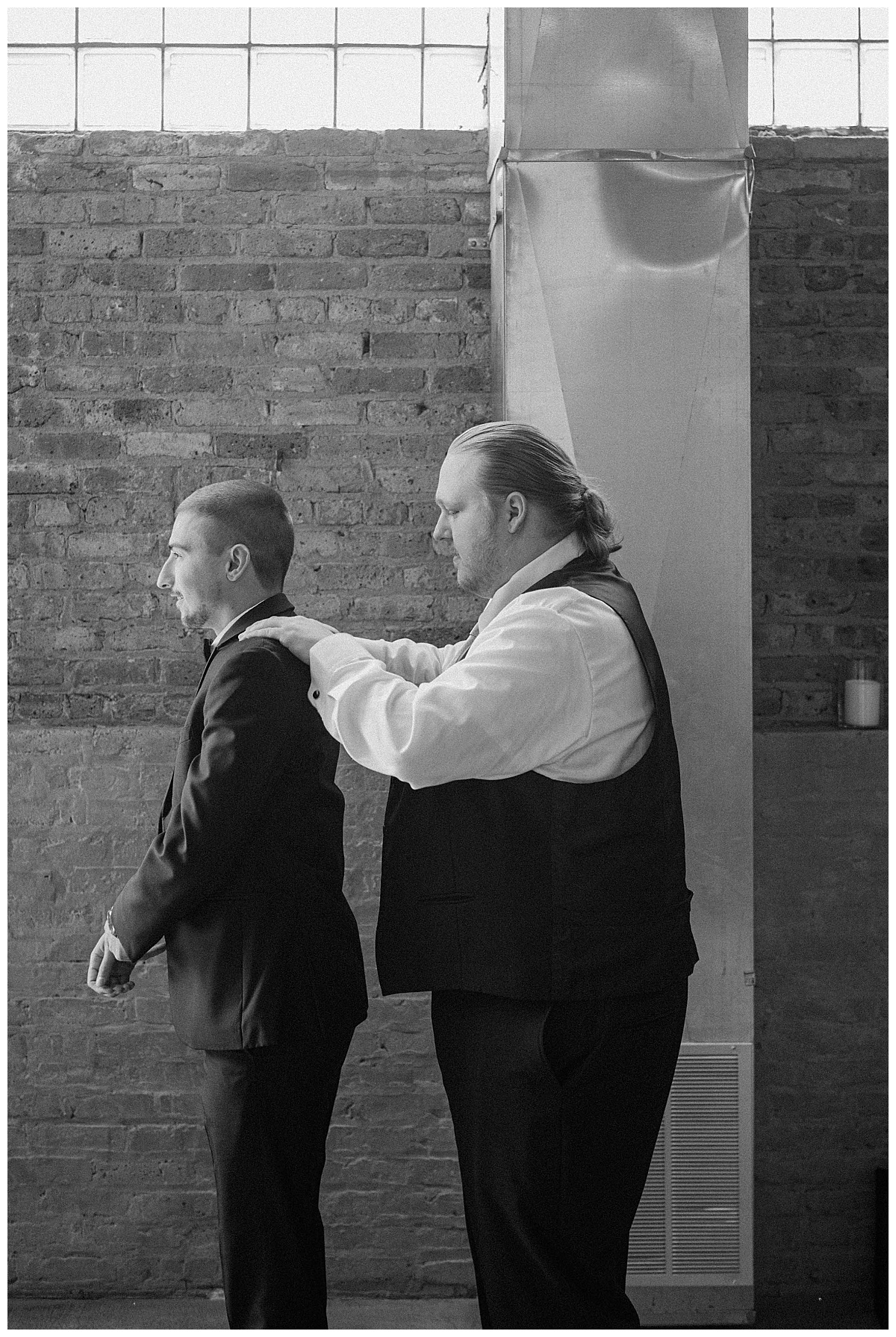 groomsman helps groom get ready for ceremony by Indigo Lace Collective 