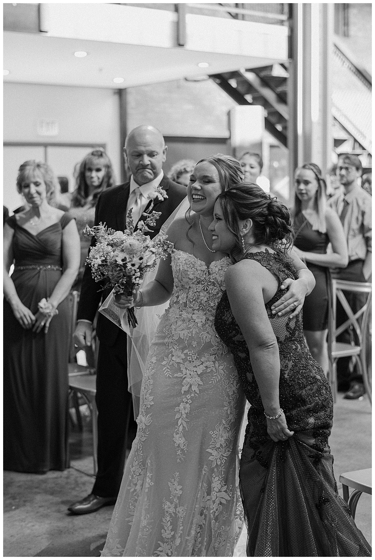 daughter hugs mother at the end of the altar at summer Fairlie wedding