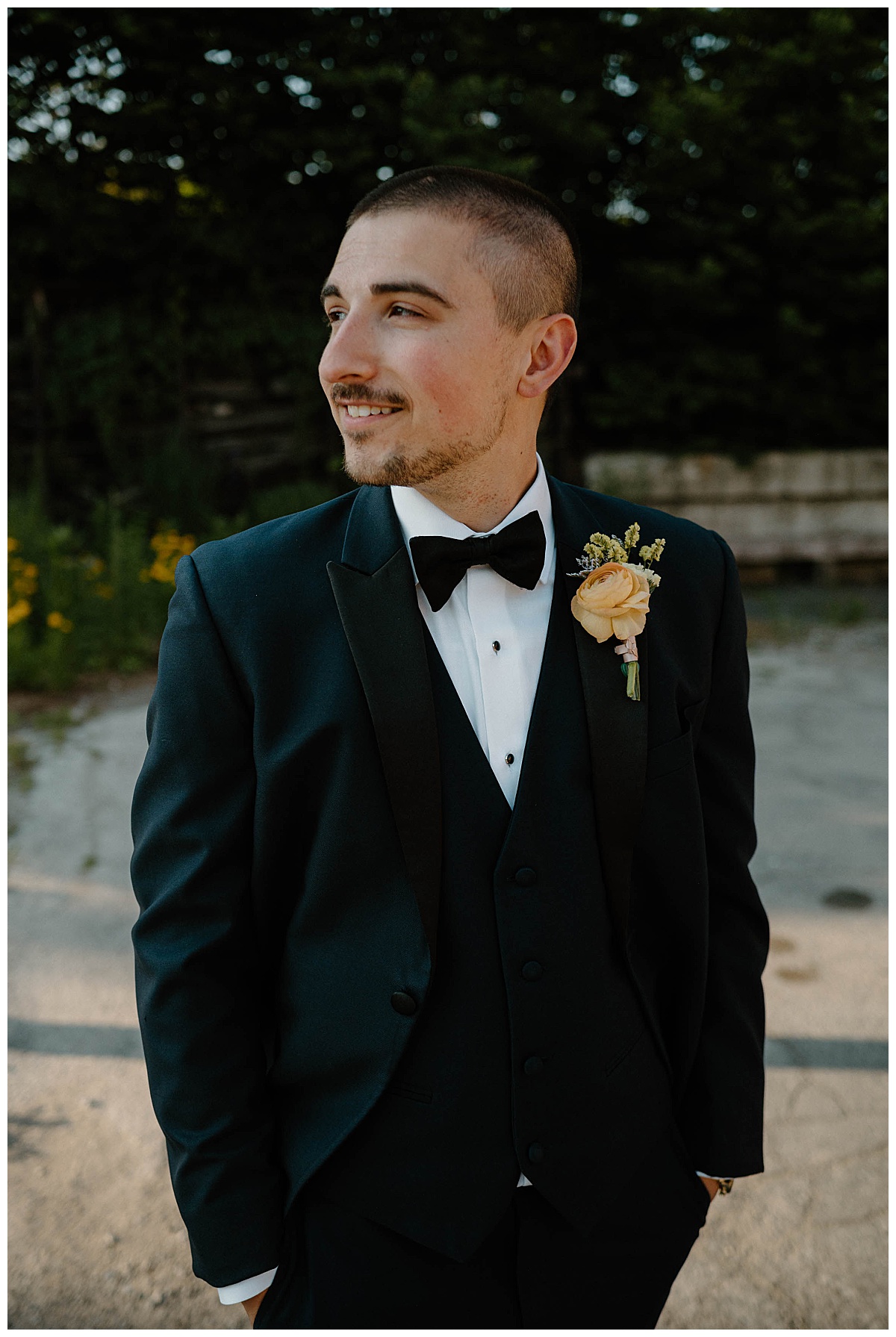 groom looks to side with hands in pockets by Chicago photographer