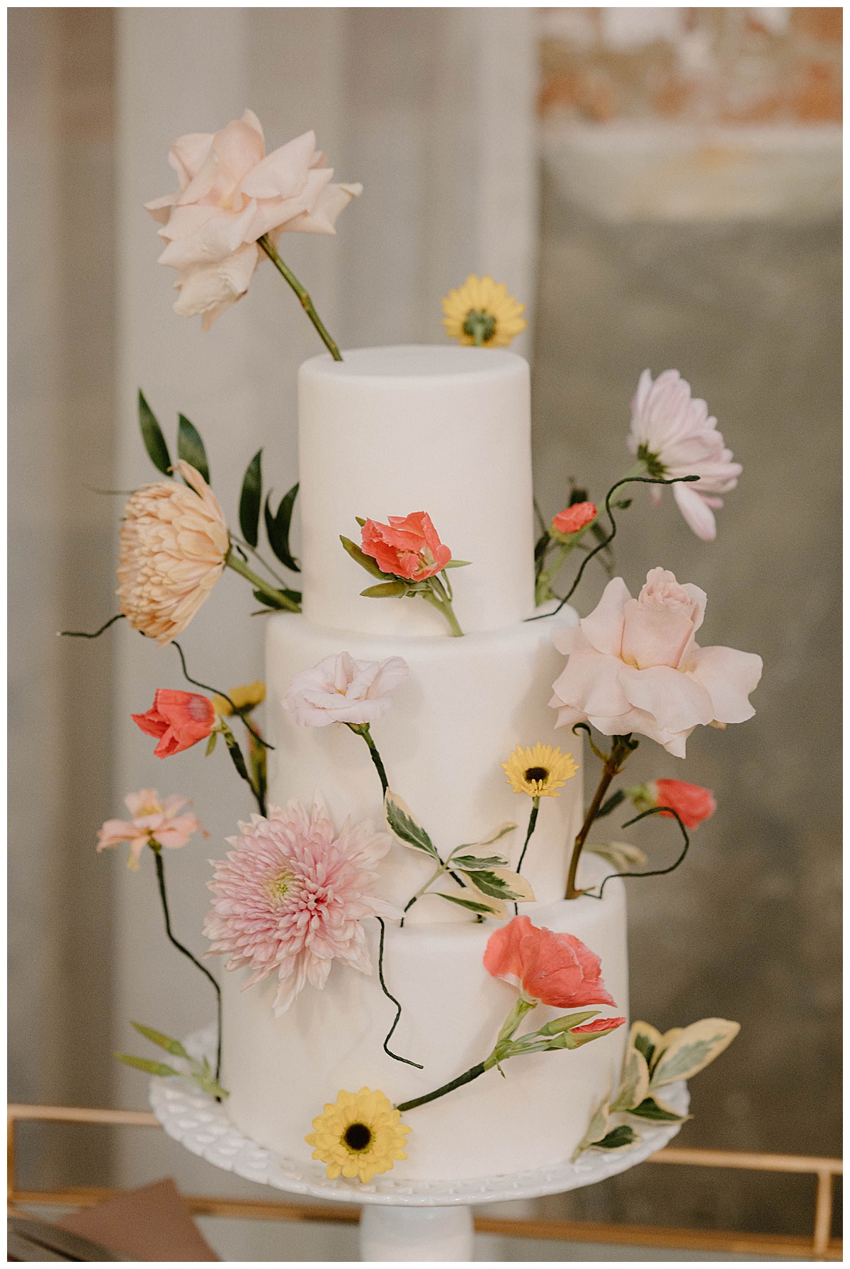 cake decorated with colorful flowers at summer Fairlie wedding