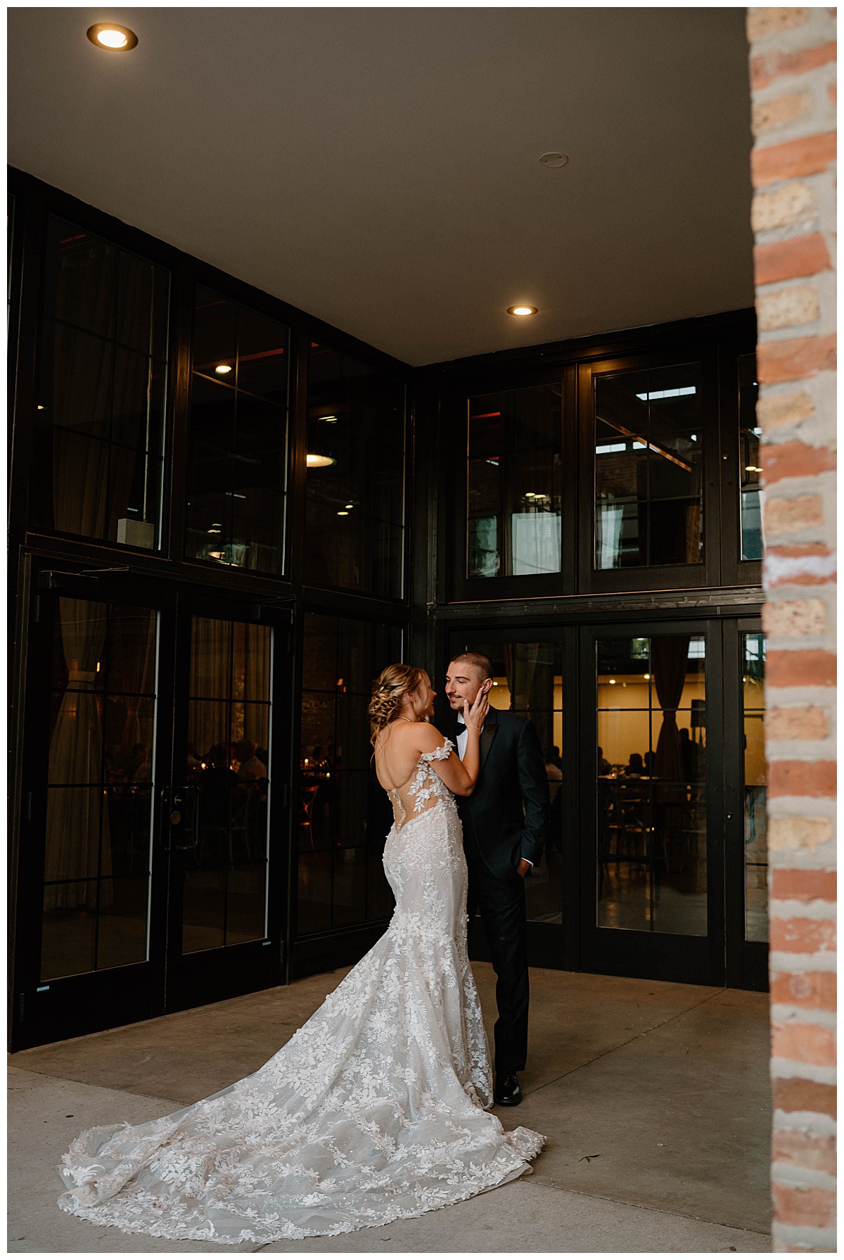 bride and groom stand outside wedding venue by Chicago photographer