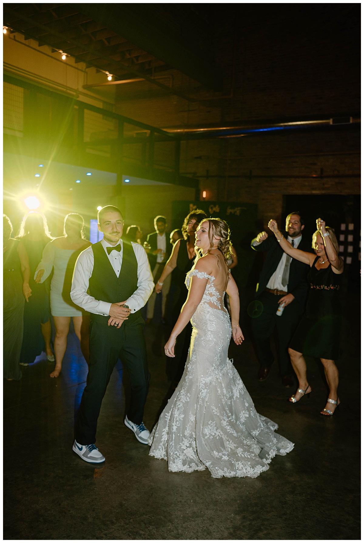 newlyweds dance with guests on dance floor by Chicago photographer