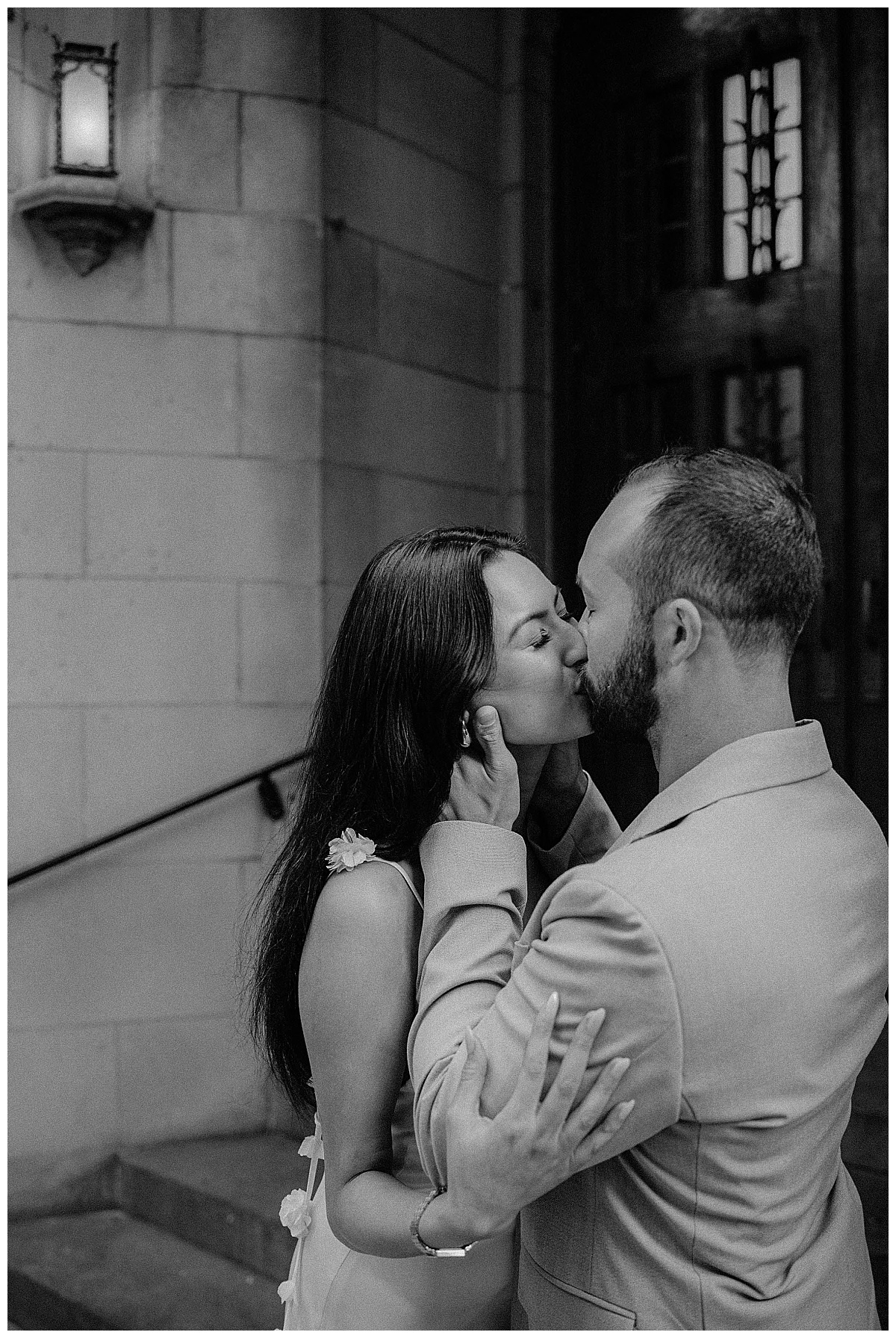 couple kisses on stoop during downtown engagement session