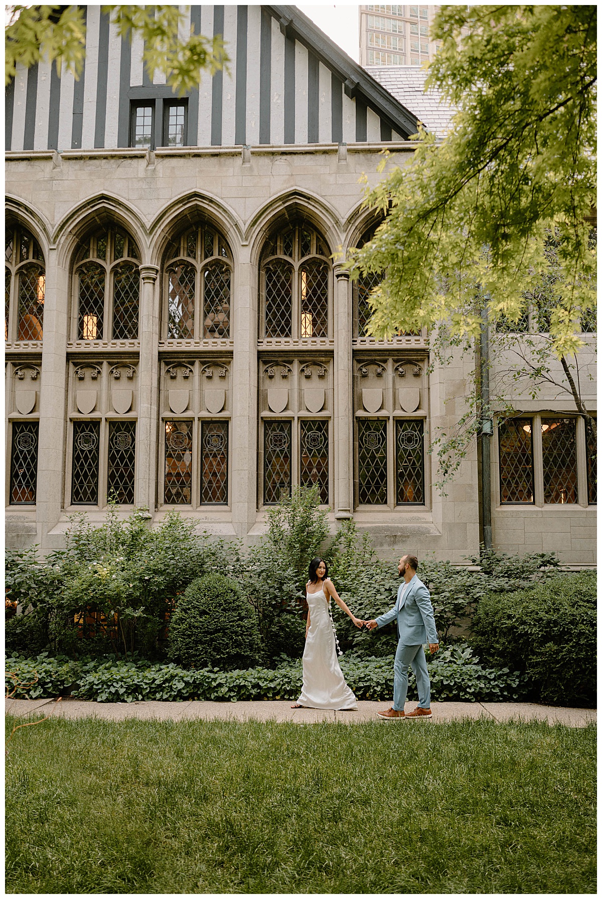 woman leads man down sidewalk by Chicago wedding photographer