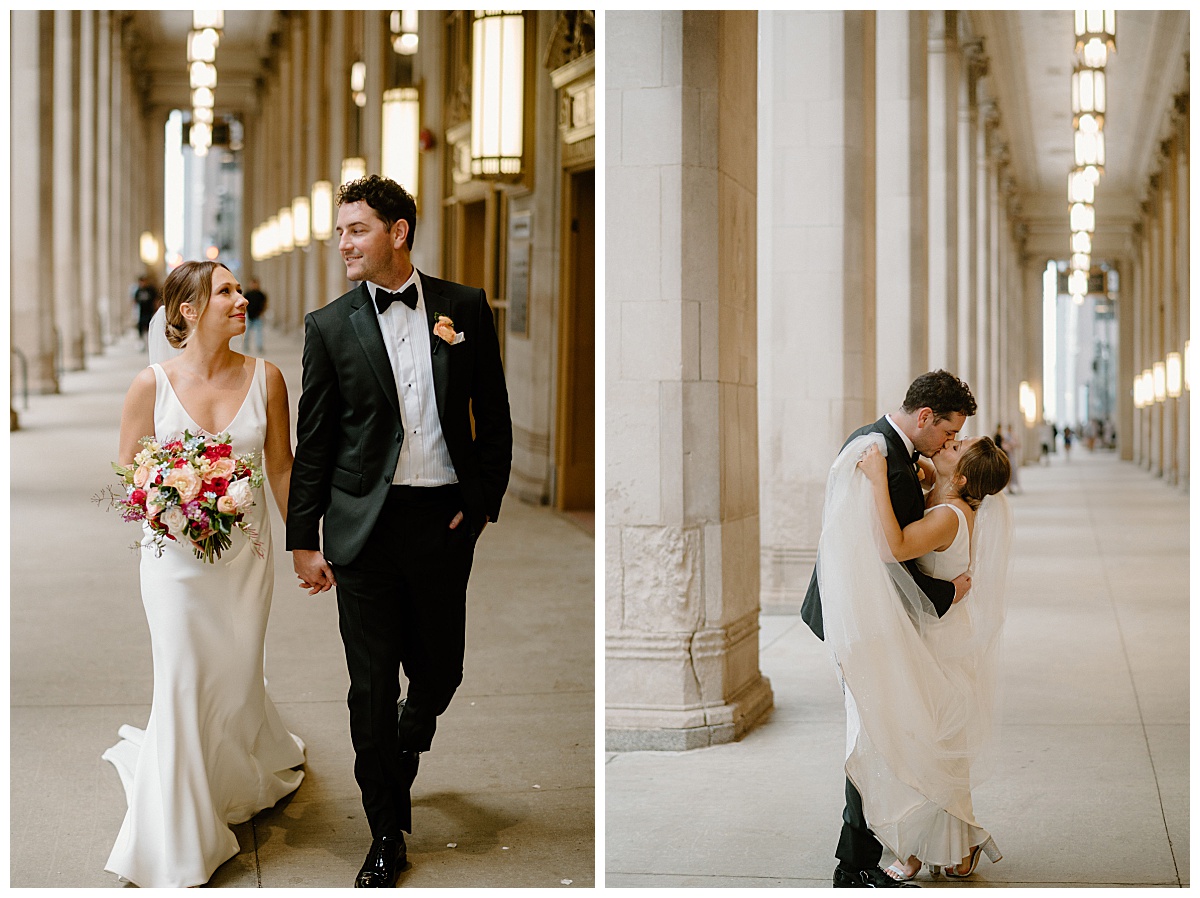 newlyweds walk together and kiss in front of large columns by Midwest wedding photographer