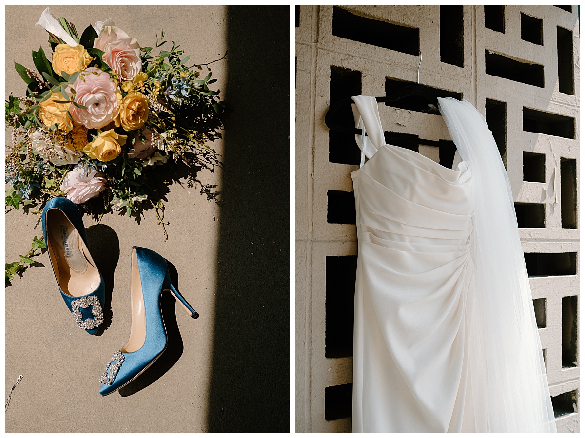 bridal bouquet and shoes lay on table while gown hangs on wall by Chicago wedding photographer