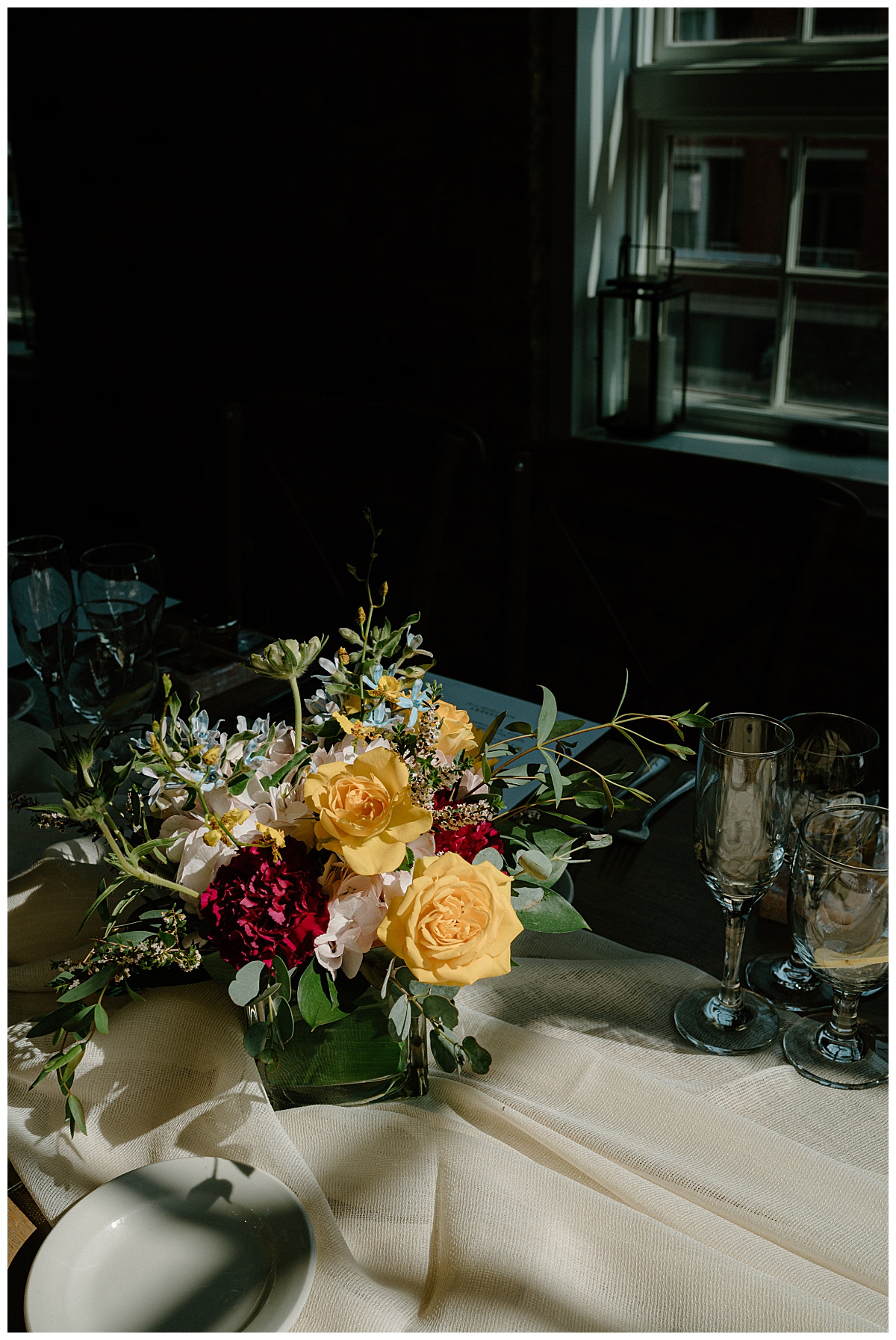 floral centerpiece adorns reception table by Chicago wedding photographer