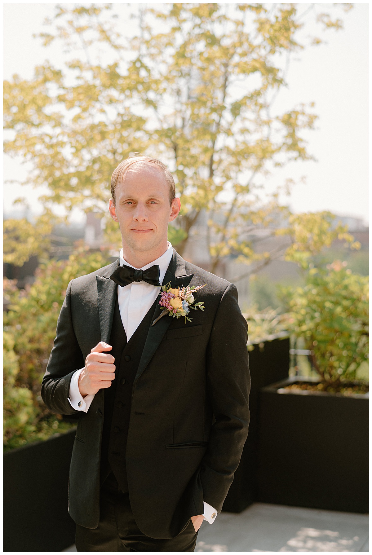 groom holds coat and puts hand in pocket by Chicago wedding photographer