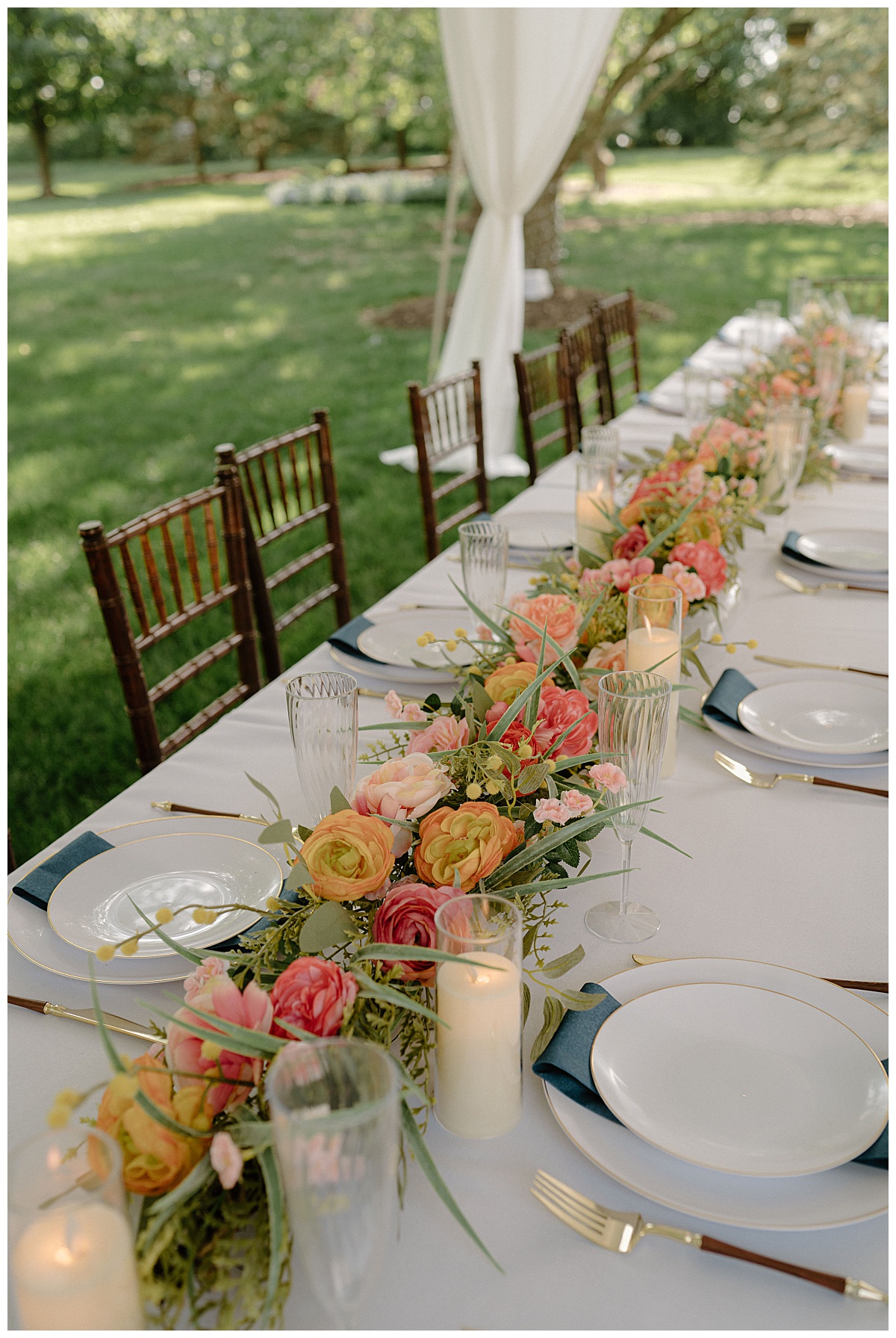 champagne flutes line up next to florals along reception table by Indigo Lace Collective