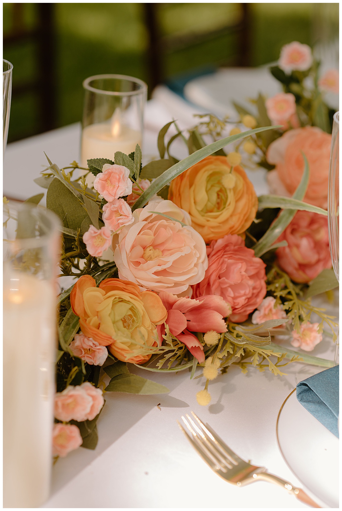 bright orange, pink, and peach florals decorate tables at backyard summer celebration