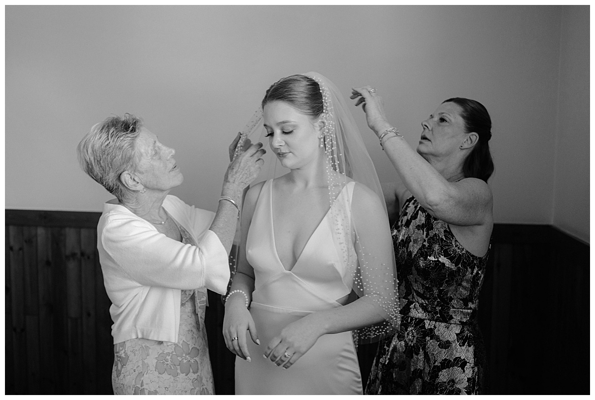 mother of the bride adjusts veil by  Midwest wedding photographer