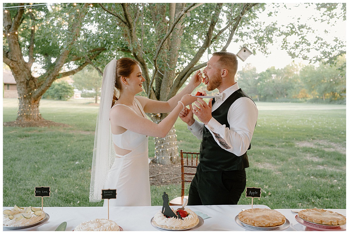 woman feeds pie to man during reception by Indigo Lace Collective