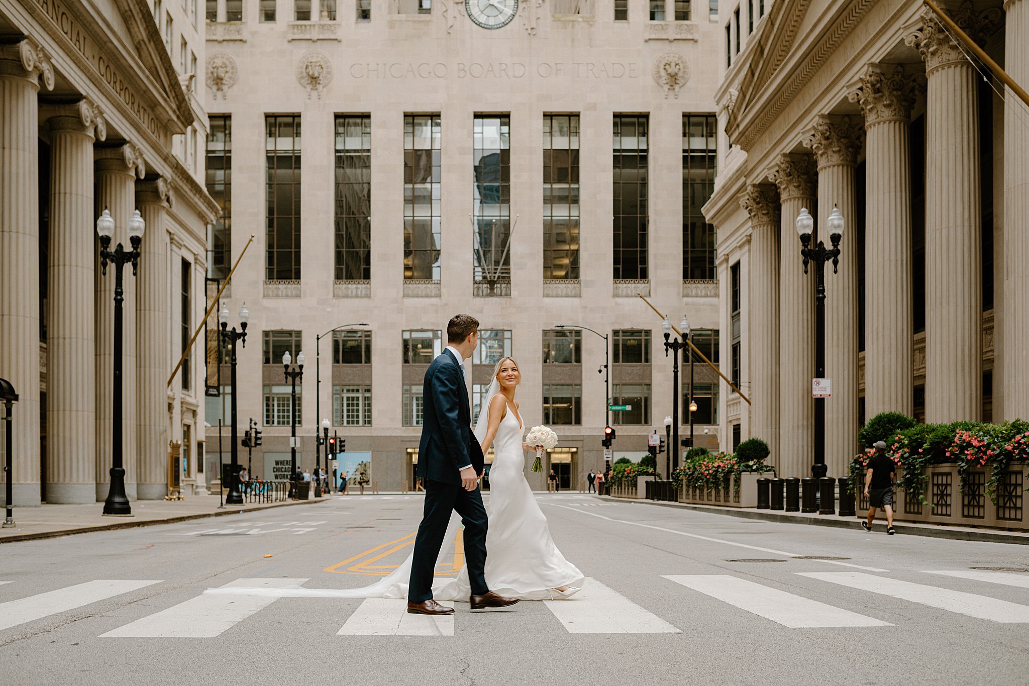 bride and groom hold hands as they cross the street before Intimate Mia Francesca Wedding