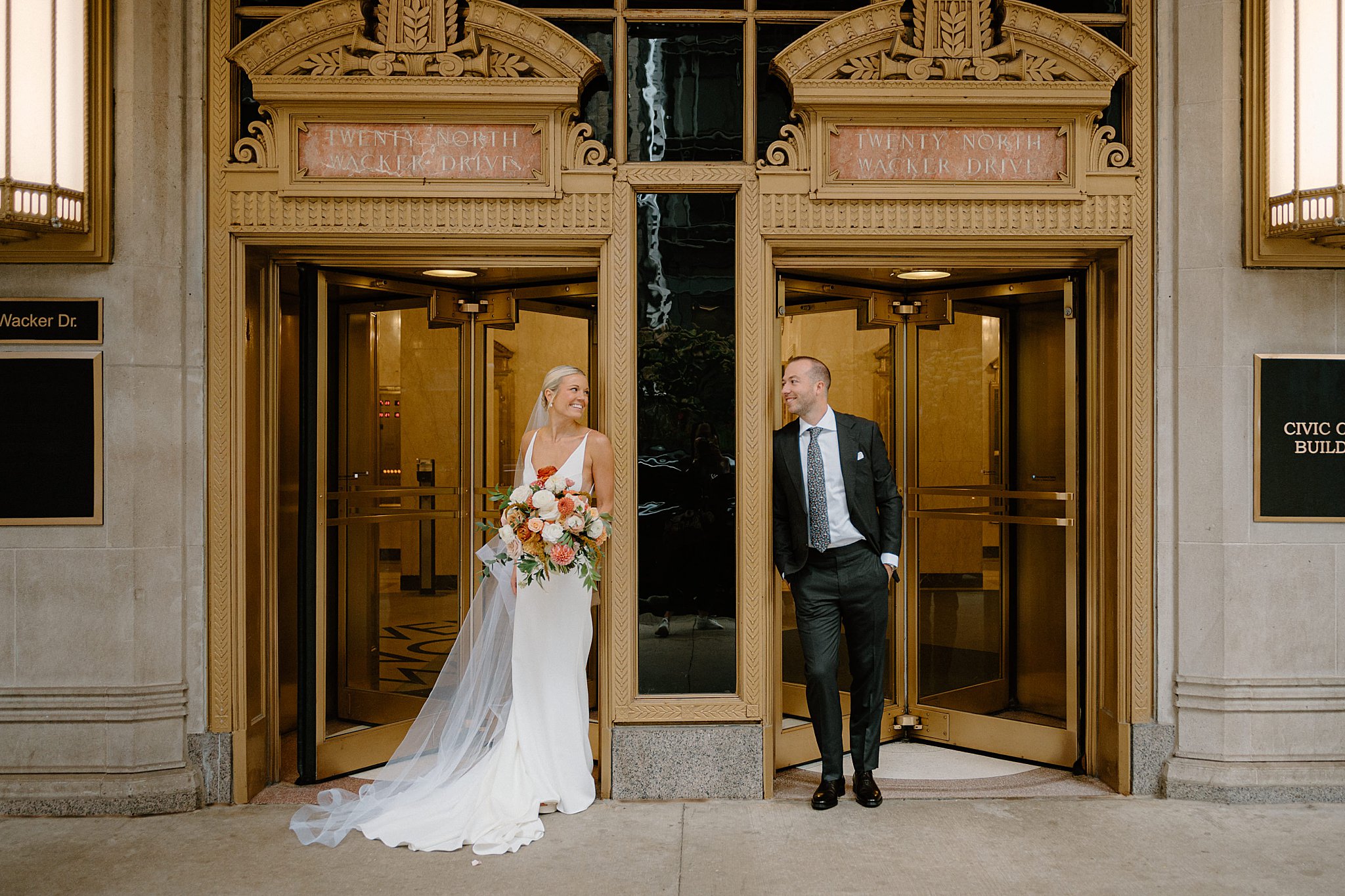 bride and groom lean on doorways looking at each other at Cafe Brauer 