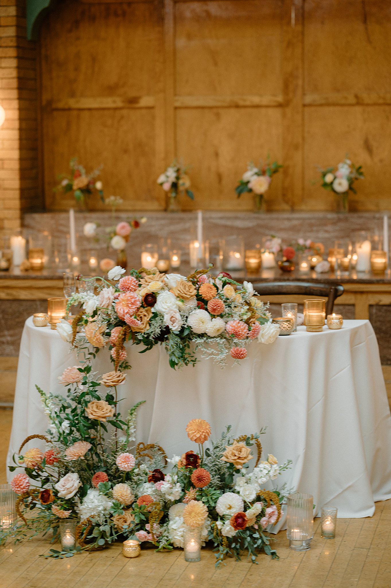 table adorned with candles and large floral pieces by Indigo Lace Collective
