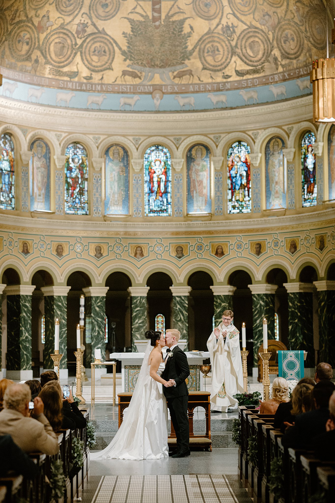 bride and groom share first kiss at the altar by Indigo Lace Collective