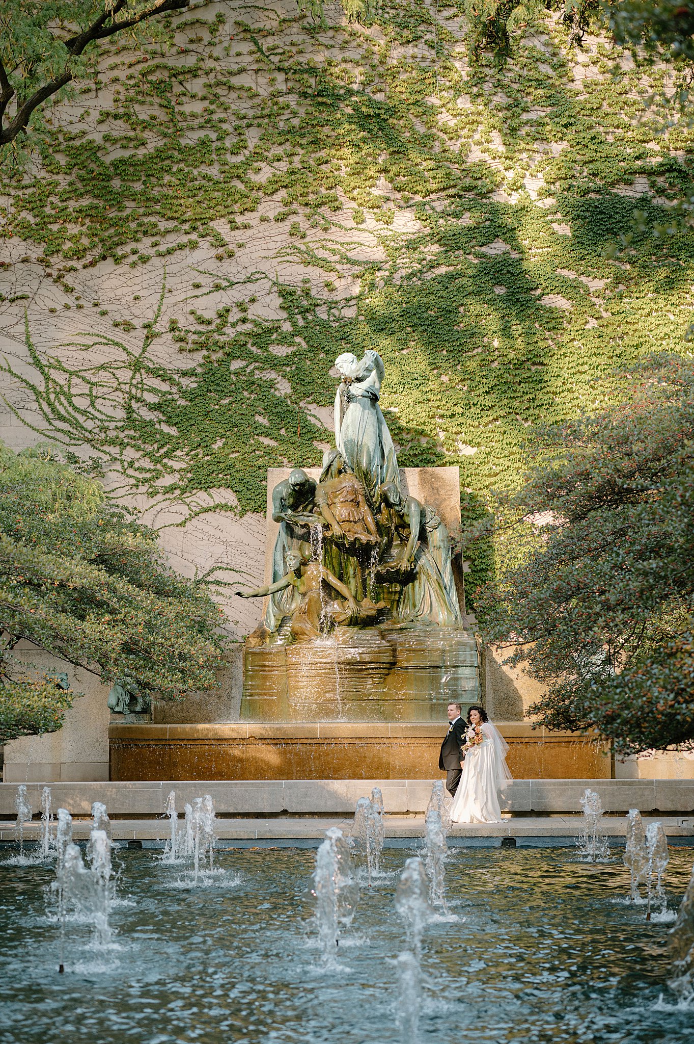 couple walks in front of large fountain at Galleria Marchetti