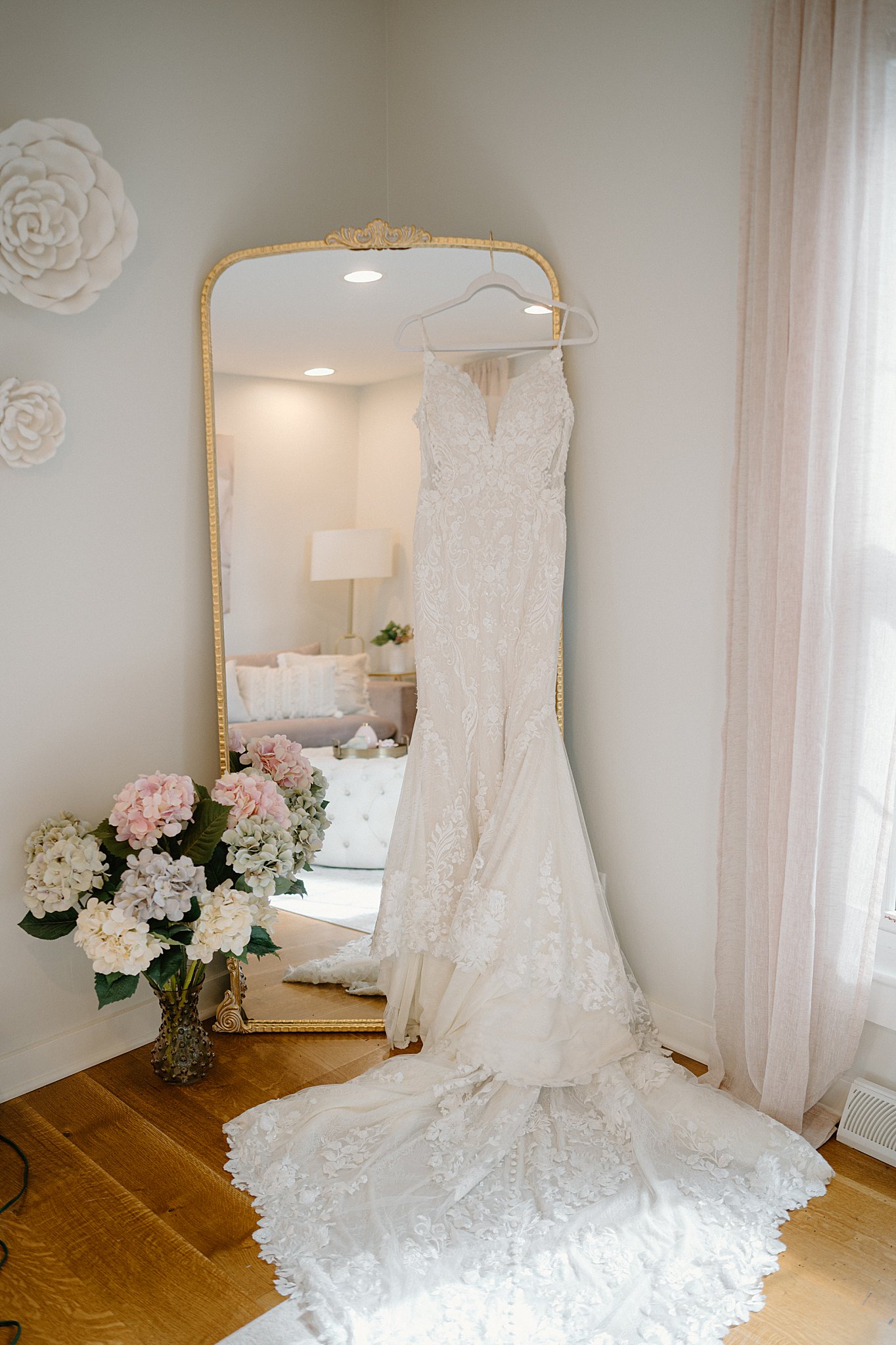 bridal gown hands on mirror by flowers by Indigo Lace Collective